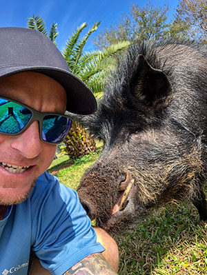 Farmer Brock Hall takes a selfie with porcine sidekick, Magnum P.I.G.