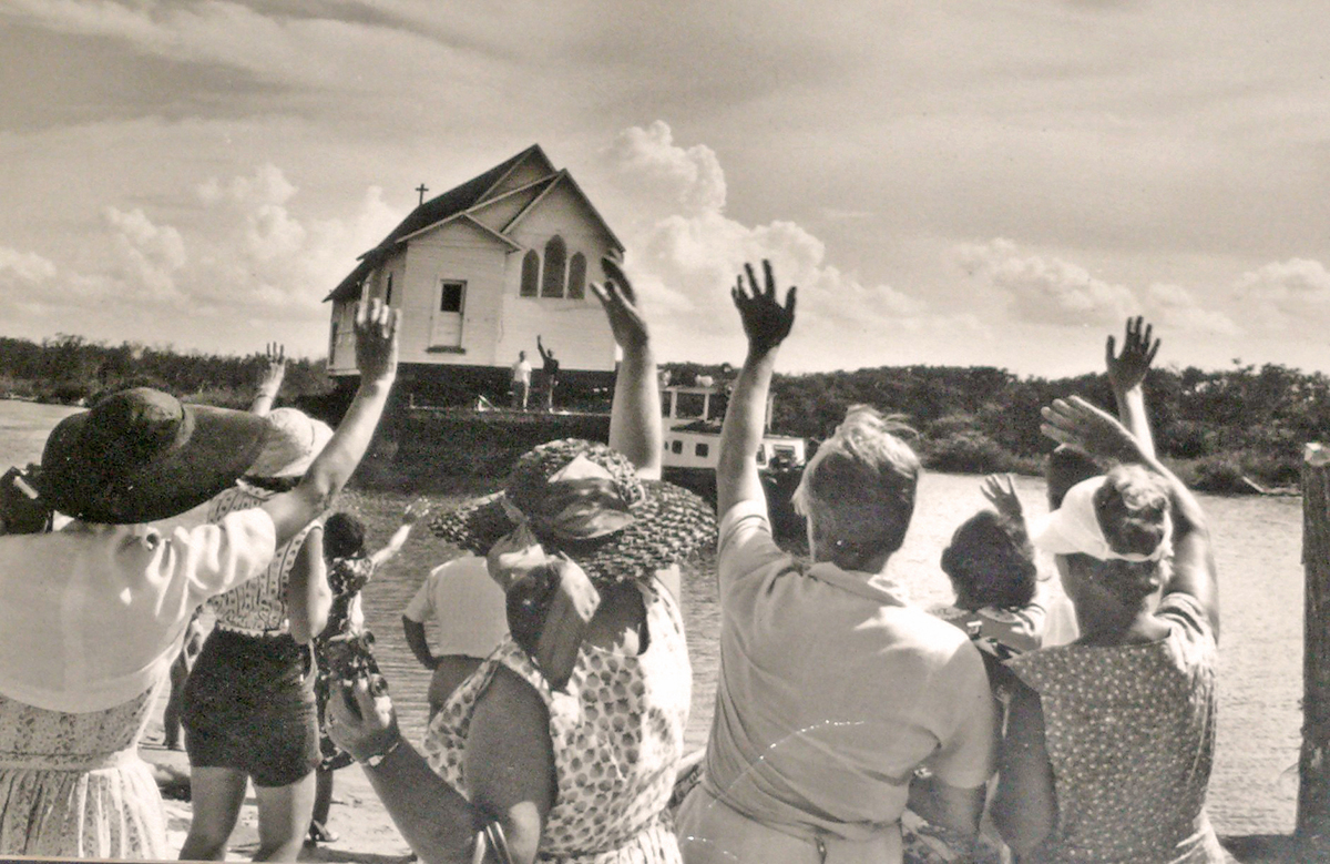 Former parishioners wave farewell to the old St. Andrew’s Episcopal Church in July 1959 as it gets underway.