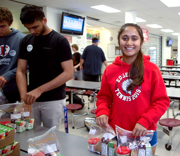 Students from Edgewood Junior/Senior High School help pack weekend meals