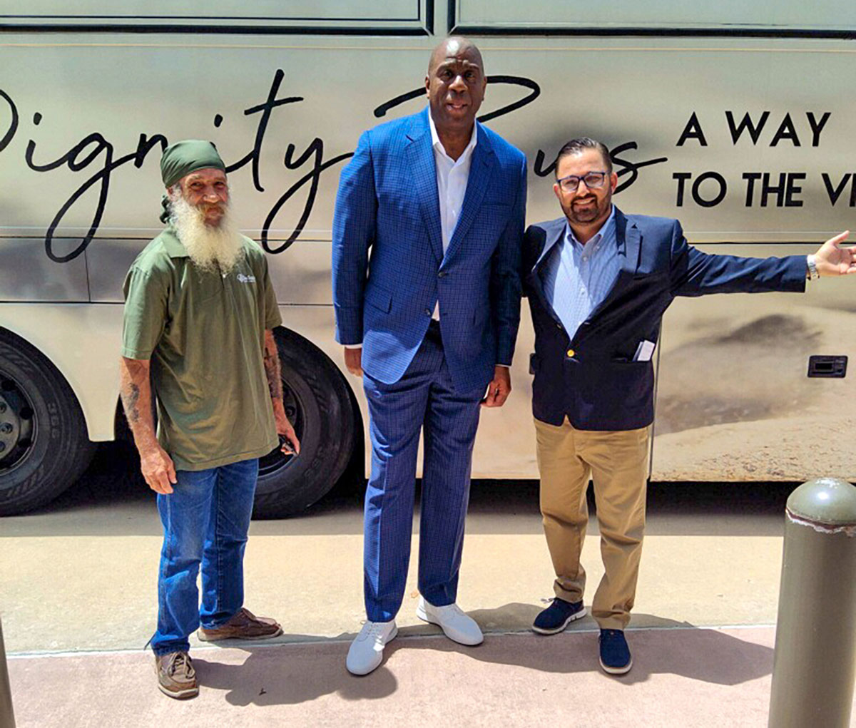 Dignity driver Kyle and The Source executive director Anthony Zorbaugh and Magic Johnson