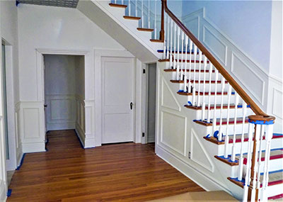 restored wood floor next to the staircase