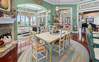 The French kitchen enclave includes double fireplaces, a counter and a table and chairs. The adjoining sunroom was the Farmers' favorite space.
