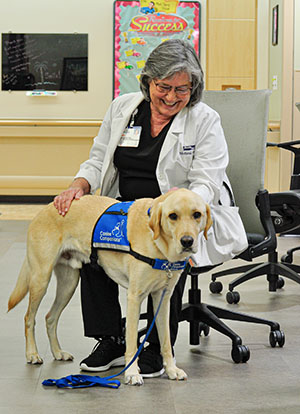 Health First Medical Group nurse practitioner Jill Polet, APRN, beams during a quick break with Jammer.