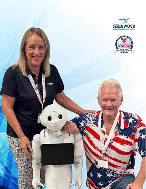 Man and woman standing next to robot